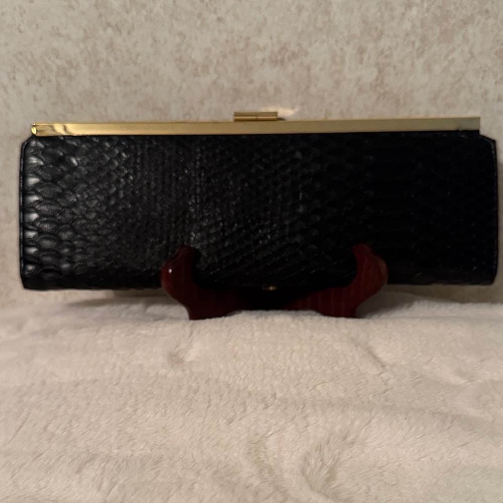 Bebe Elegant Black Snake skin Clutch.